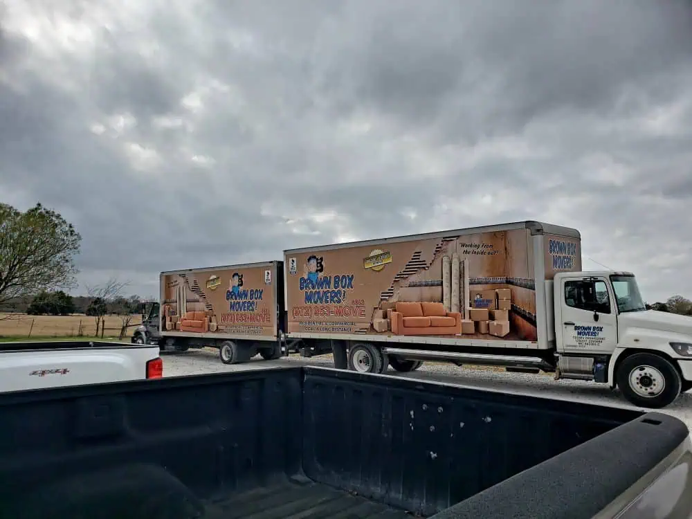 Brown Box Movers truck parked in an open lot