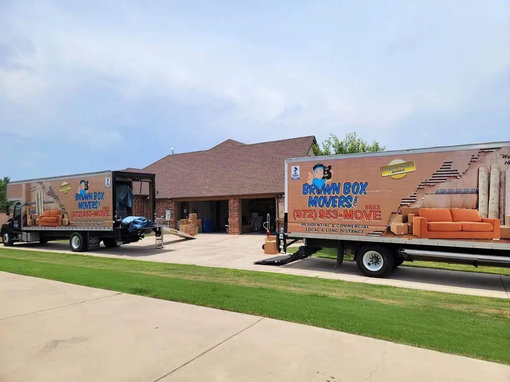 Brown Box Movers truck parked in front of a brick house