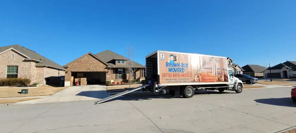 Brown Box Movers truck parked outside a home