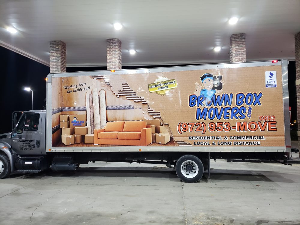 Brown Box Movers truck parked in a covered garage before an apartment move