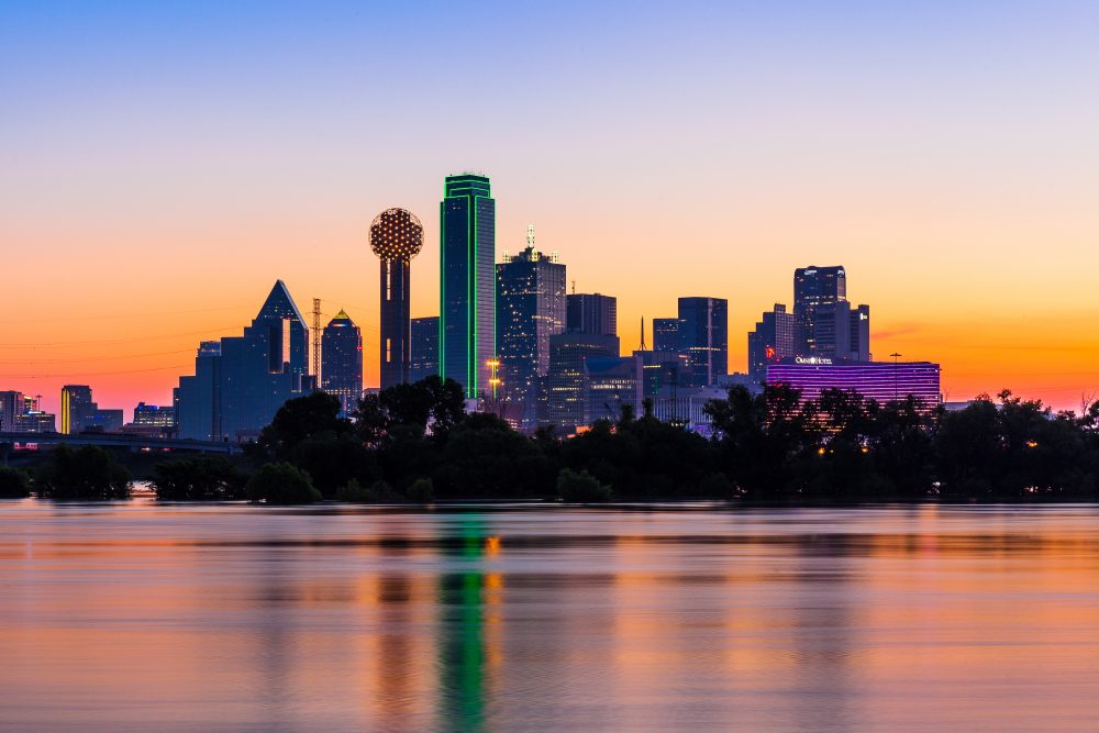 Dallas skyline at sunset reflected over the water