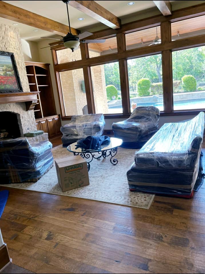 Living room furniture wrapped in plastic during an estate clean-out