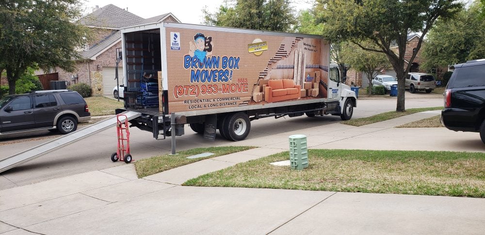 Brown Box Movers truck backed into a driveway