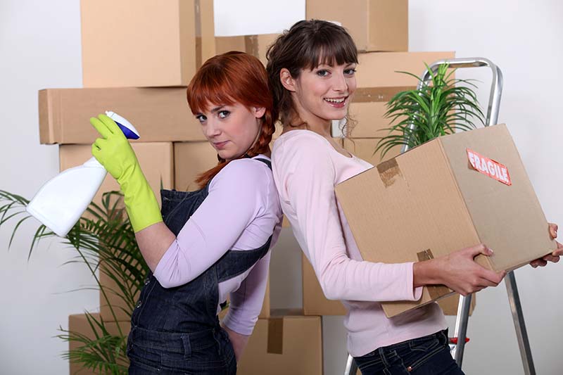 Two women cleaning an empty home before move-out