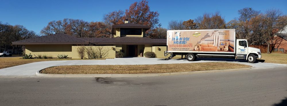 Brown Box Movers truck parked outside a home before a long-distance move