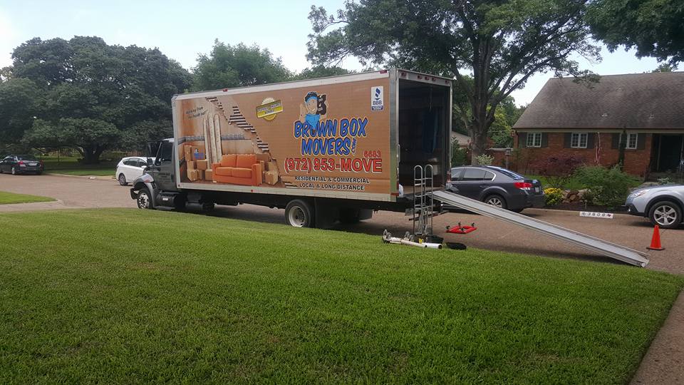 Moving truck with loading ramp on a residential street