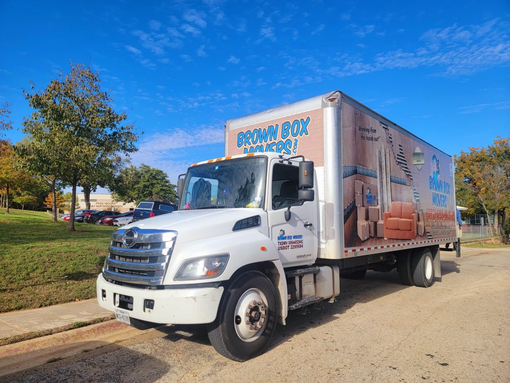 Brown Box Movers truck parked on a sunny residential street
